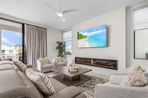 a living room with a couch and a fireplace at Oyster Cluster in Fort Myers Beach
