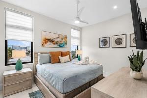 a bedroom with a bed in a room with windows at Oyster Cluster in Fort Myers Beach +42 photos