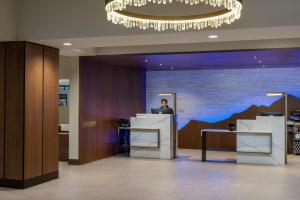 a man sitting at a desk in a lobby at Sheraton Steamboat Resort Villas in Steamboat Springs +81 photos