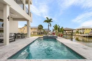a swimming pool in the backyard of a house at Oyster Cluster in Fort Myers Beach