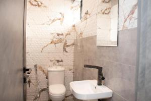 a bathroom with a toilet and a sink at The Maridoc in Lagos +65 photos