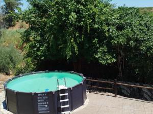 a large hot tub in front of a tree at Casa Rural del Guadalora in Hornachuelos