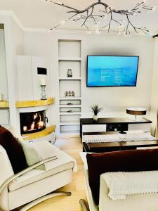 a living room with a fireplace and a flat screen tv at Apartament z kominkiem i prywatnym mini SPA in Gdynia