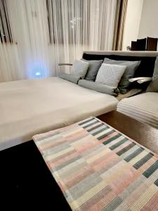 a large bed in a room with a rug at Apartament z kominkiem i prywatnym mini SPA in Gdynia