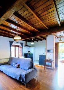 a living room with a blue couch and a table at Casa Chisco in Cudillero