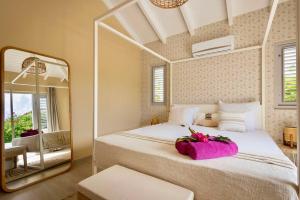a bedroom with a large bed with a large mirror at Villa Flores Corales 84 - Coral Estate in Willibrordus +7 photos
