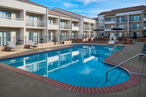 a swimming pool in front of a building with a hotel at Courtyard Birmingham Hoover in Hoover