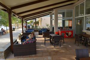 a man sitting on a patio in a restaurant at Korali in Almiropótamos