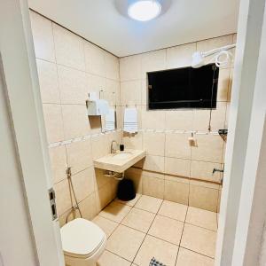 a bathroom with a toilet and a sink at Studio Palm Garden em Nova Andradina in Nova Andradina +48 photos