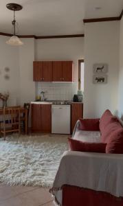 a kitchen and a living room with a bed at Valley Parnass in Arachova