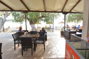two people sitting at a table in a restaurant at Korali in Almiropótamos