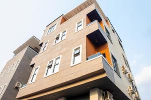 a tall brown building with white windows at The Maridoc in Lagos