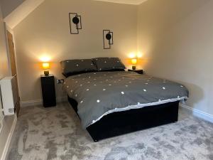 a bedroom with a bed with two lamps on it at Studio 1 in Howden