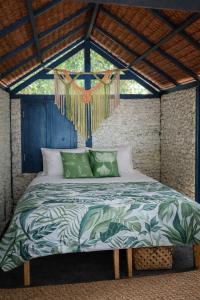 a bed in a room with a large window at Beachfront on Aore Island Private Island Stay in Aimbuei Bay