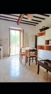 a living room with a table and chairs in it at Maria Luisa Home in Poggibonsi