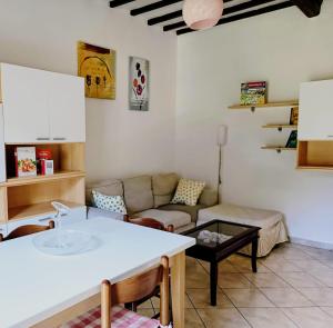 a living room with a couch and a table at Maria Luisa Home in Poggibonsi