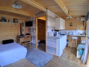 a bedroom with a bed and a kitchen with a counter at Bay Stay in Greenhill
