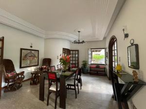 a dining room with a table and chairs at Villa Chayol - Beautiful, spacious, bright! in Cotonou