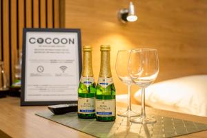 two bottles of champagne and two glasses on a table at Conco Leipzig in Leipzig