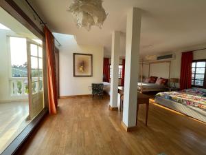 a room with a bed and a bedroom with a window at Villa Chayol - Beautiful, spacious, bright! in Cotonou +23 photos