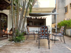 a patio with chairs and a table in a building at Villa Chayol - Beautiful, spacious, bright! in Cotonou