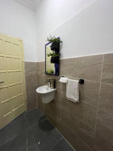 a bathroom with a sink and a mirror at Bendo house in Accra +30 photos