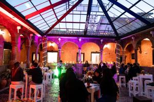a group of people sitting at tables in a building at Ayni Boutique Hotel in Cusco