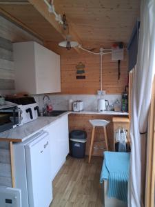 a kitchen with white cabinets and a counter top at Bay Stay in Greenhill +53 photos