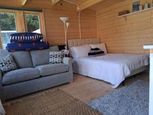 a living room with a couch and a bed at Bay Stay in Greenhill