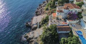an aerial view of a house on a cliff next to the water at Aleksandra Apartments Utjeha in Utjeha