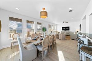 a dining room and living room with a table and chairs at Doc's Folly in Gulf Shores
