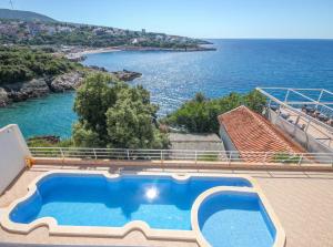a swimming pool with a view of the ocean at Aleksandra Apartments Utjeha in Utjeha