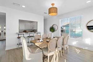 a dining room and kitchen with a table and chairs at Doc's Folly in Gulf Shores