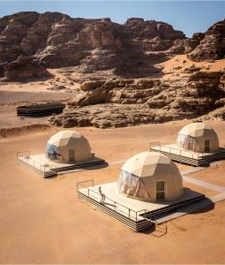 a group of three tents in the desert at Moonlight Luxury Bubble Camp & Jeep Tours in Wadi Rum