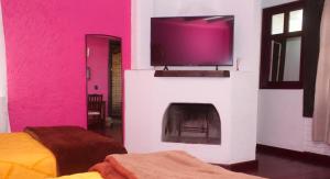 a living room with a tv and a fireplace at HOTEL & RESTAURANTE Los solaches in Zitácuaro