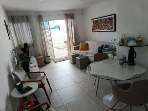 a living room with a table and a couch at Alameda Jardim Serra Negra in Bezerros