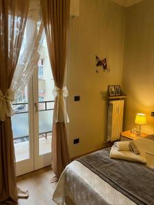 a bedroom with a bed and a large window at Angy's House in Verona