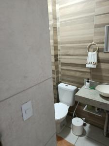 a bathroom with a toilet and a sink at Alameda Jardim Serra Negra in Bezerros +10 photos