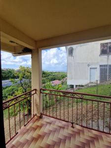 a balcony with a view of a building at Holiday rental House in Schœlcher +7 photos