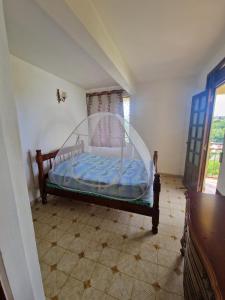 a bedroom with a bed with a canopy at Holiday rental House in Schœlcher