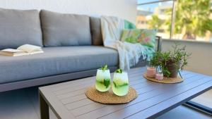 a living room with a couch and a coffee table at MG Playa Flamenca Village in Orihuela Costa