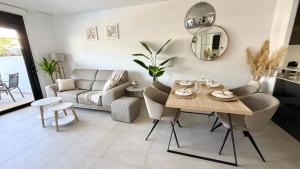 a living room with a table and a couch at MG Playa Flamenca Village in Orihuela Costa