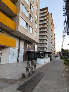 a building with metal sculptures in front of it at Departamento Barcelona in Temuco