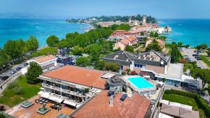 an aerial view of a town with a swimming pool at Alevic Hotel Sirmione in Sirmione