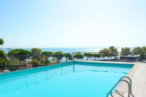 a swimming pool with a view of the ocean at Alevic Hotel Sirmione in Sirmione