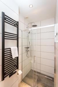 a shower with a glass door in a bathroom at Conco Leipzig in Leipzig +35 photos
