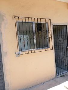 a window with bars on the side of a building at Kitnet Ateneu in Vila Velha