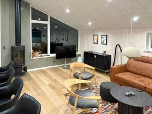 a living room with a couch and a fire place at Architect-Designed House In Juelsminde in Juelsminde