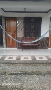 a bench with a rope in front of a building at Cabinas Smith 2 in Cahuita +16 photos