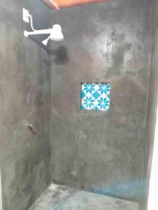 a shower with a glass door with a window at Dell Ville Cabin in Barreirinhas
